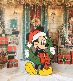 the mickey mouse christmas card is on display in front of a room full of presents