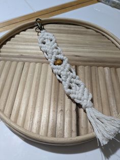 a close up of a tassel on a wooden tray