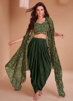 Bottle satin readymade dhoti set cape suit 5351 Crop top with Dhoti set and shrug style cape suit 3 pcs set. Crop top and Dhoti in satin with original mirror work embroidery, resham work and cape suit in organza fabric with digital print work. Desc:  Style : Dhoti Style crop top cape suit  Color :Bottle green  Fabric : Satin,Organza Wash Care : Dry clean Sleeve Style : cape ,Work: embroidery and digital print Long Sleeves : Done only in Custom Stitch Sleeves Lining : Done only in Custom Stitch Bust Size : Free size 40 to 42 Inches Occasion : Wedding   Festival   Christmas   Diwali   Sangeet   Reception   Ceremonial   Dussehra. With Express Free Shipping and Custom Stitching, Buy Indian Party wedding and bridal Anarkalis Bottle satin readymade dhoti set cape suit 5351 online in US Dhoti Style Dresses, Dhoti Salwar Suits, Wedding Salwar Kameez, Silk Crop Top, Gaun Fashion, Dhoti Pants, Embroidered Crop Tops, Indo Western Dress, Lehenga Choli Online