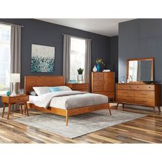 a bedroom scene with focus on the bed and dresser