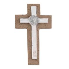 the cross is made out of concrete and has a silver medal on it's side