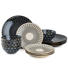 black and white dinnerware set with geometric designs on the plates, cups and saucers