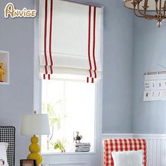 a bed room with a neatly made bed next to a window and a chandelier