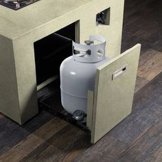 a propane gas tank is open on the floor next to a wall mounted cabinet