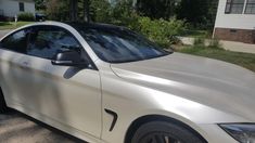 a silver car parked in front of a house