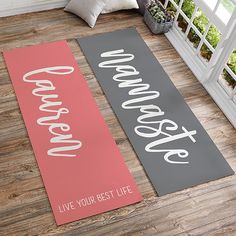 two yoga mats with the words live your best life printed on them in front of a window