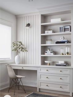 a white desk and some shelves in a room