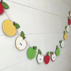 an apple garland is hanging on the wall