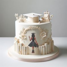 a graduation cake decorated with an image of a woman holding a graduate's cap