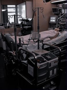 an empty hospital room with medical equipment on the bed and in the background are monitors