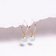 Aqua Chalcedony Earrings - 14k Gold Filled Hoop Wire Earrings, Dainty, Timeless, Minimalist Earrings - Genuine Chalcedony round facet stones Gemstones: 9x6mm approximately Bezel: Vermeil Gold (14k Gold over Sterling Silver) Ear Wires: 14K Gold Filled Wire: 21 gauge / 0.70mm thick Wire Diameter: 15mm Gemstone: Genuine Aqua Chalcedony Note that due to the handmade nature of these genuine stones, measurements are approximately and might vary slightly for each stone. Arrives in giftbox. Made in t... Chalcedony Earrings, Store Jewelry, Gold Filled Hoops, Earring Ideas, Minimalist Gifts, Aqua Chalcedony, Earrings Dainty, Wire Earrings, Agate Pendant