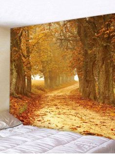 a wall hanging on the side of a bed next to a forest filled with trees