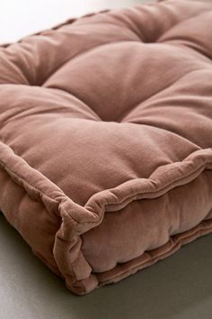 a brown square cushion sitting on top of a table