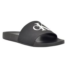 A warm weather essential, the Calvin Klein Arin sandals are a must have for your wardrobe. This comfortable, slip-on look features a modern square toe and CK monogram detailing on the upper. Founded in New York in 1968, the brand elevates everyday essentials to globally iconic status. | Calvin Klein Women's Arin Beach Slide Slip-On Sandals, Black, 7M Classic Flat Slides For Summer, Modern Black Slides For Summer, Modern Black Flip Flops For Spring, Calvin Klein Sandals For Beach And Spring Season, Calvin Klein Sandals For Spring Vacation, Casual Calvin Klein Sandals For Vacation, Calvin Klein Sandals For Beach In Spring, Calvin Klein Casual Sandals For Vacation, Calvin Klein Beach Sandals For Spring