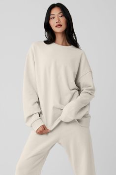 Chill Crew Neck Pullover - Bone | Alo Yoga Super Soft Athleisure Sweatshirt With Cozy Fit, Super Soft Cozy Fit Athleisure Sweatshirt, Sporty Sweats By Alo Yoga, Alo Yoga Sporty Relaxed Fit Sweats, Alo Yoga Relaxed Fit Cotton Top, Relaxed Fit Crew Neck Top With Elastic Cuffs, Cozy Crew Neck Top With Ribbed Waistband, Crew Tops With Elastic Cuffs For Loungewear, Crew Top With Elastic Cuffs For Loungewear