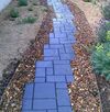 there is a blue brick path going up the hill