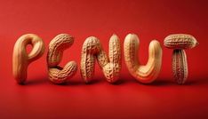 the word peanut spelled with peanuts on a red background