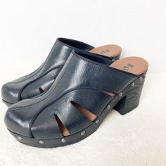 Korks Neneh Mules Size 7 Black Leather Leather Cut Out Clogs With Chunky Wood Look Heel 3” High Excellent Condition Never Worn Black Synthetic Block Heel Clogs, Black Synthetic Clogs With Buckle Closure, Black High Heels Clogs & Mules, Killer Heels Clogs & Mules, Black Mules With 4-inch Wedge Heel, Leather Cuts, Mule Clogs, Mules Shoes, Clogs