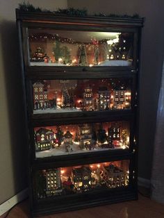 a lighted display case filled with lots of christmas decorations and lights on top of it