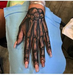 a person's hand with a tattoo on it