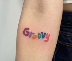 the word grooy written in multicolored ink on the left upper arm