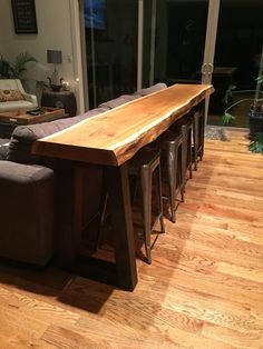 a wooden table sitting on top of a hard wood floor