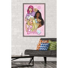 barbie poster hanging on the wall next to a couch