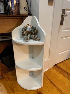 a corner shelf with a teddy bear on it