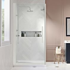 a bathroom with a walk in shower next to a white sink and mirror on the wall