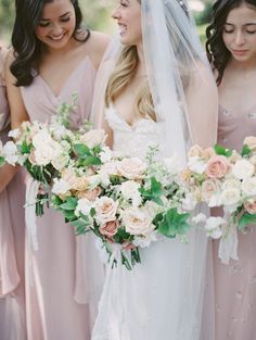 the bride and her bridesmaids are holding their bouquets