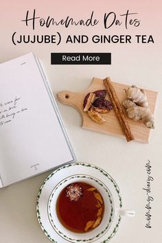 the recipe book is next to a cup of tea on a plate with cinnamon sticks