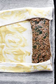 an uncooked loaf of bread sitting on top of a piece of parchment paper