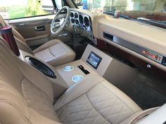 the interior of a car with beige leather seats and electronic controls on the dash board