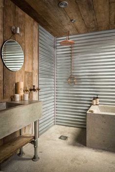 a bathroom with a sink, mirror and bathtub in the middle of wood paneled walls