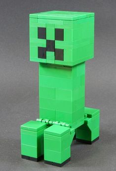 a green lego creeper sitting on top of a table