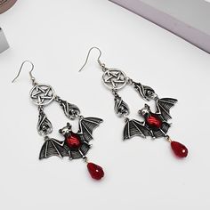 These earrings feature red vampire bat wings with a bangle and have a pentacle design. The pentacle is a symbol of protection and balance. They are mighty and can help you connect with your dark side. Wearing these can boost your confidence and make you feel protected. It's the perfect accessory for you and will surely add magick to any outfit. Specification： Material: AlloyTreatment process: electroplatingSize: 3.07"x1.81" (7.8x4.6cm)Package Size: 80 x 80 x 30 mm Red Vampire, Symbol Of Protection, Vampire Bat, Bat Wing, Wing Earrings, Bat Wings, Dark Side, Make You Feel, Bat