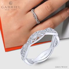 A flawless mixture of filigree detailing and magnificent .23ct pave diamonds create this one of a kind stackable ring. The contoured silhouette is crafted from polished 14k white gold for timeless elegance. LR6317W45JJ #FineJewelry#FashionJewelry#UniqueJewelry#GiftIdeas#UniqueGifts #DiamondJewelry #Jewelry #Mother'sDay#Ladies'Ring#DiamondStackable Modern Twist Open Band Diamond Ring, Modern Stackable Rings In Diamond White, Elegant Stackable Wide Band Ring For Wedding, Engraved Wide Band Ring For Anniversary, Elegant Wide Band Ring For Wedding, Open Band Rings With Diamond Accents, Designer Wedding Rings With Diamond Accents, Elegant Wide Band Ring With Diamond Accents For Wedding, Elegant Wide Band Wedding Ring With Diamond Accents