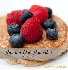 pancakes with raspberries and blueberries are on a white plate that says banana - oat pancakes 2 day fix