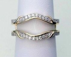 an image of two wedding rings with diamonds on top of each other in yellow gold and white gold