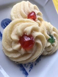 two cookies with jelly on them sitting on a blue and white plate