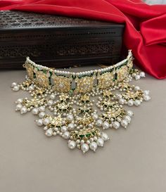 A glamorous bridal jewelry set for the contemporary bride of today! Beautiful meenakari kundan necklace set embellished with kundan stones and pearls detailing. The set includes a princess necklace, a tika and a pair of beautiful long earrings.  Details: Princess Necklace: Upper Choker Width-1.25 Inches Lower Choker Width-4 Inches Earrings Length-4.5 Inches Weight of Each Earring-21 gma Tika Length-7 Inches All products are manufactured using traditional skills from our rich heritage of crafts. Silver Kundan Necklace With Zari Work For Ceremonial Occasions, Ceremonial Kundan Necklace Hand Set, Kundan Choker With Meenakari For Reception, Ceremonial Kundan Necklace With Pallu, Kundan Cutdana Temple Necklace For Receptions, Ceremonial Kundan Necklace With Cutdana For Eid, Ceremonial Kundan Necklace For Eid With Cutdana, Ceremonial Hand Set Kundan Necklace, Bollywood Kundan Choker For Reception