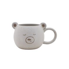 a ceramic mug with a bear face on it