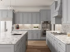 a large kitchen with gray cabinets and marble counter tops