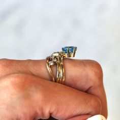 Stunning & unique vintage 14k yellow gold ring featuring a genuine swiss blue topaz gem. The asymmetrical ring contains 6 sparkling diamond accents, with an oval cut blue topaz weighing approximately 1.47 carats. A truly rare & one of a kind gemstone ring! ERA - Circa 1980s METAL / MATERIAL - 14k yellow gold, 1 genuine blue topaz gemstone (estimated 1.47 carats), 6 genuine diamonds (approx. .30 ctw, SI clarity range, near colorless) MARKINGS / HISTORY - Inside of band is stamped 14k COND Classic Gold Blue Topaz Birthstone Ring, Gold Blue Topaz Diamond Ring For Anniversary, Gold Oval Blue Topaz Birthstone Ring, Classic Anniversary Topaz Birthstone Ring, Gold Birthstone Ring With Blue Topaz And Accent Stones, Heirloom Topaz Birthstone Ring For Anniversary, Heirloom Blue Topaz Ring For Anniversary, Heirloom Blue Topaz Anniversary Ring, Gold Solitaire Blue Topaz Ring