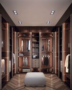 a large walk in closet with lots of clothes