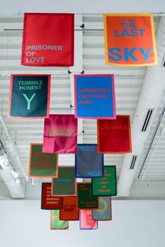 colorful banners hanging from the ceiling in a building