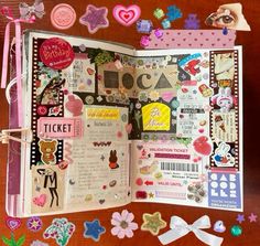 an open scrapbook with lots of stickers and decorations on the pages, along with other items