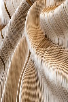 an abstract photo of wavy wood grained paper with white and brown lines on it