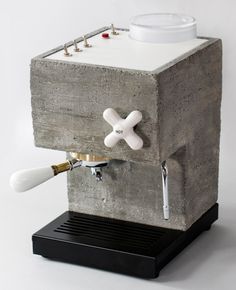 a machine made out of concrete with white handles