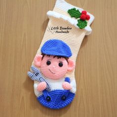 a knitted christmas stocking with a small boy holding a baseball bat on it